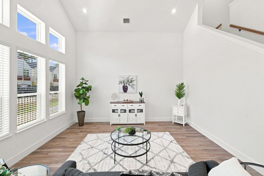 Expansive living room with soaring ceilings, abundant wall space, and multiple windows bringing in plenty of natural light. Expansive living room with soaring ceilings, abundant wall space, and multiple windows bringing in plenty of natural light.