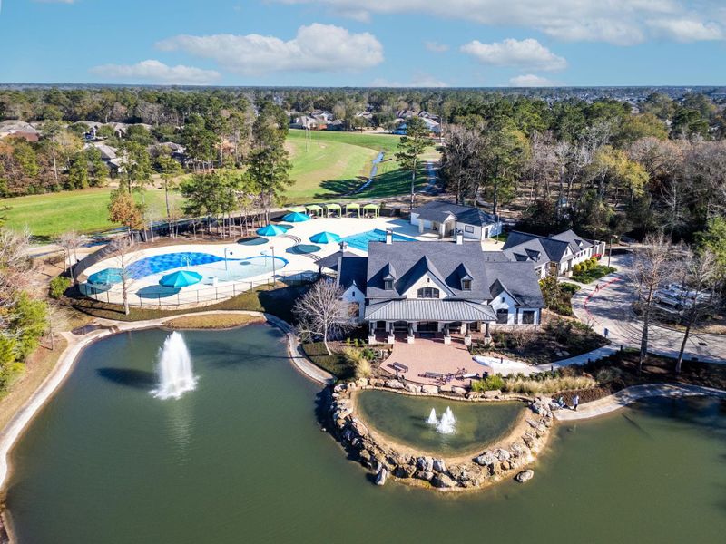 This photo showcases a picturesque neighborhood clubhouse with a large pool area, surrounded by lush greenery. There's a serene pond with fountains in the foreground, creating a tranquil setting. Perfect for families seeking a vibrant community atmosphere. This photo showcases a picturesque neighborhood clubhouse with a large pool area, surrounded by lush greenery. There's a serene pond with fountains in the foreground, creating a tranquil setting. Perfect for families seeking a vibrant community atmosphere.