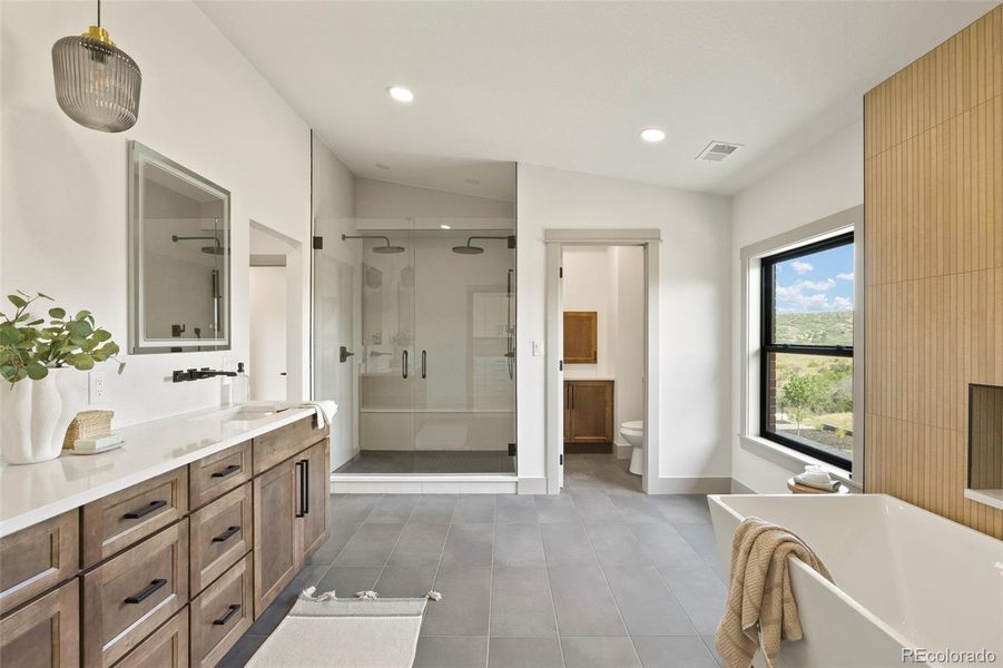 Primary en suite with dual rain heads and over-sized soaking tub.