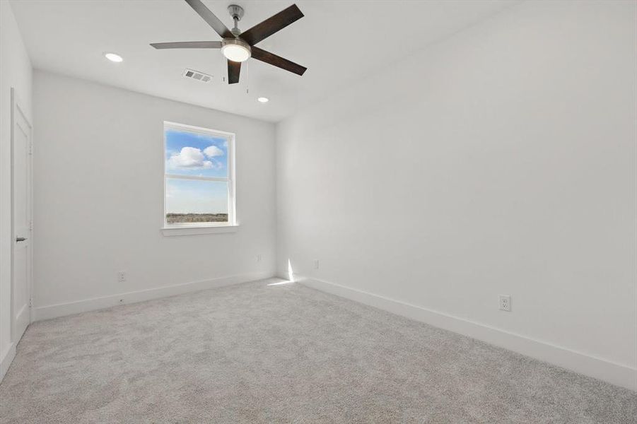 Unfurnished room featuring recessed lighting, visible vents, light carpet, and baseboards