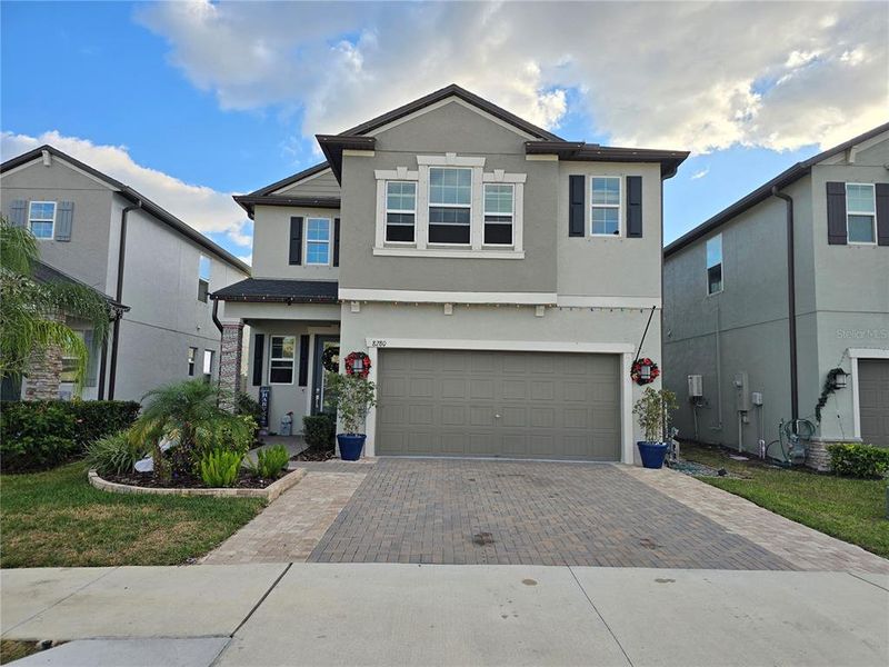Front exterior of a new home in Bryant Square: The Manors, New Port Richey, FL, highlighting curb appeal (Image 27).