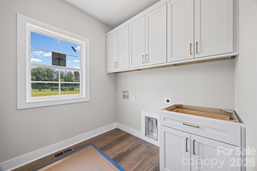 Main level laundry room with plenty of storage.