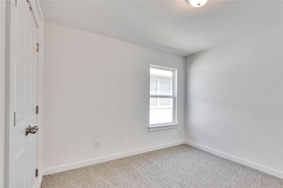 Carpeted spare room featuring baseboards Carpeted spare room featuring baseboards