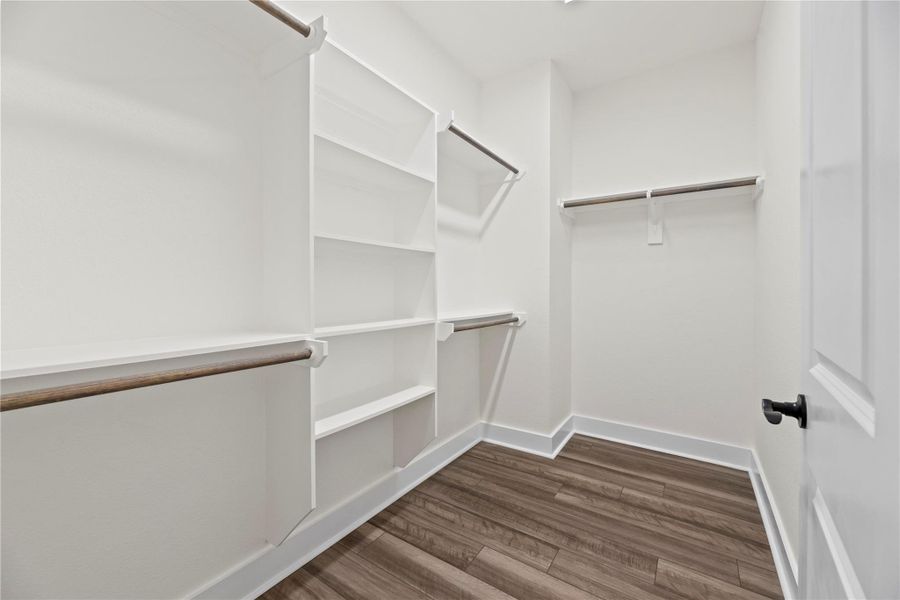 No matter how often you purchase new threads online or at the mall, this walk-in primary bedroom closet has space for all your new and favorite wares! High ceilings also afford the possibility of additional shelving or easy stacking. No matter how often you purchase new threads online or at the mall, this walk-in primary bedroom closet has space for all your new and favorite wares! High ceilings also afford the possibility of additional shelving or easy stacking.