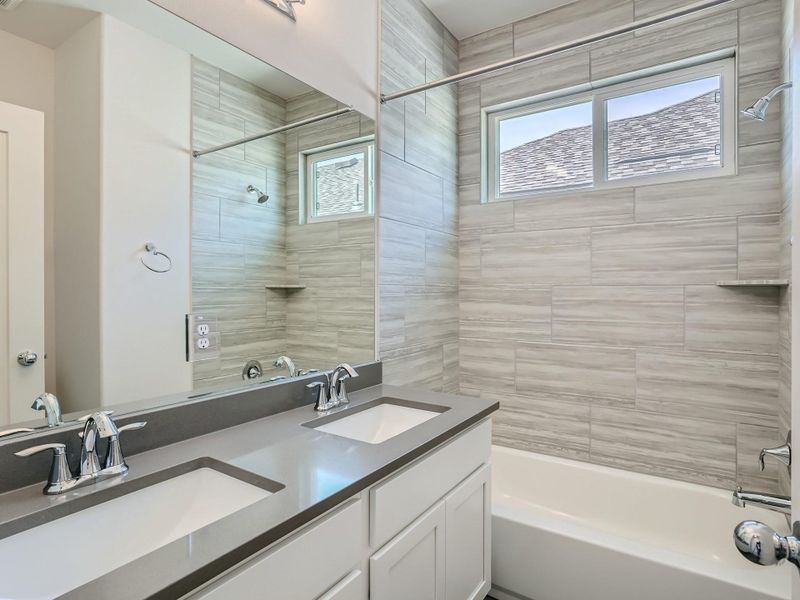 Bathroom with vanity and tiled shower / bath