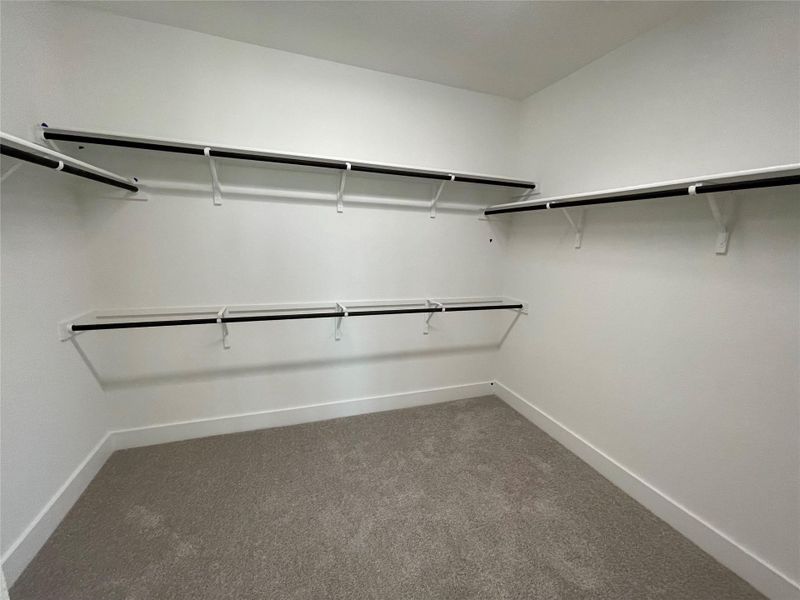 Walk-in closet in Primary Bedroom Walk-in closet in Primary Bedroom