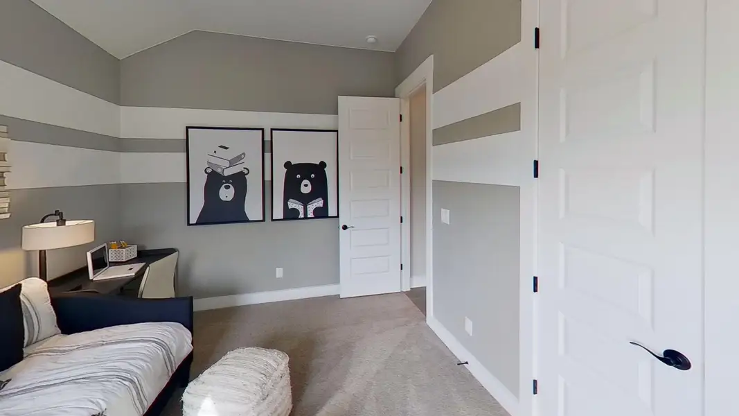 Living area with light carpet and vaulted ceiling