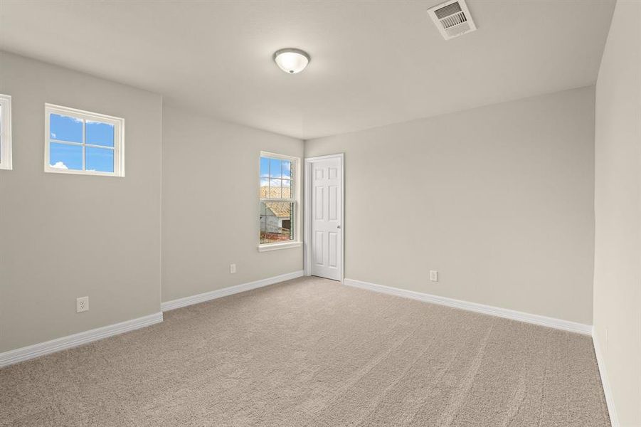 Your secondary bedroom features plush carpet, fresh paint, closet, and a large window that lets in plenty of natural lighting.