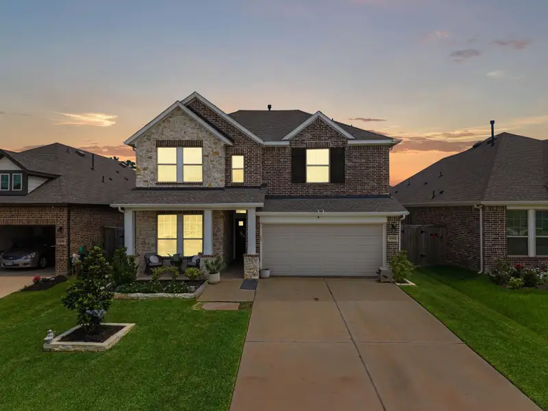 Front exterior of a new home in , Magnolia, TX, highlighting curb appeal (Image 22).