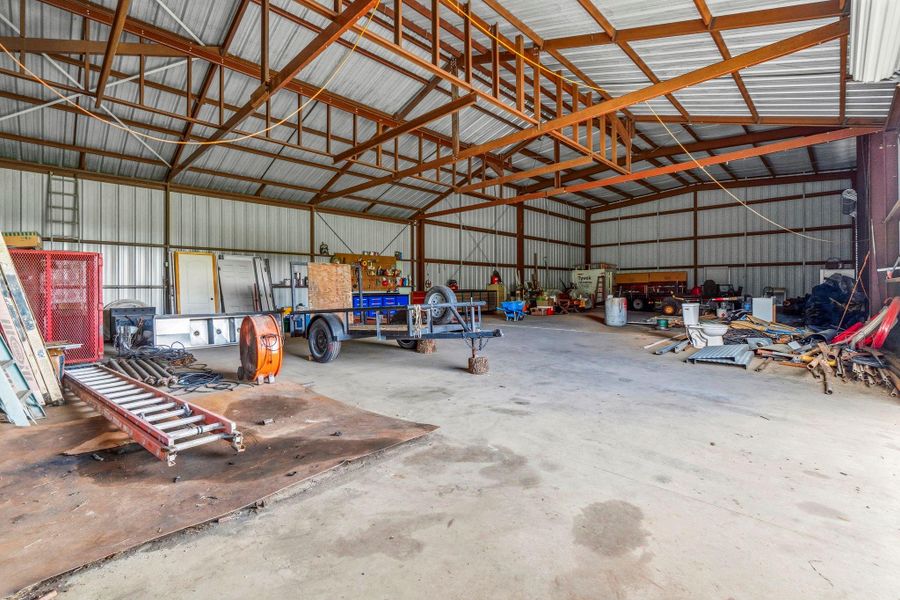 This section features a 16-ft ceiling and a roll-up door, offering convenient access and versatile space for storage or workspace use.
