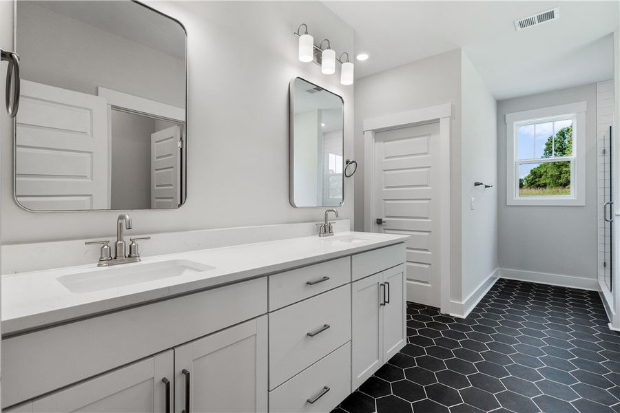 Dual vanities with sleek countertops and chic hexa