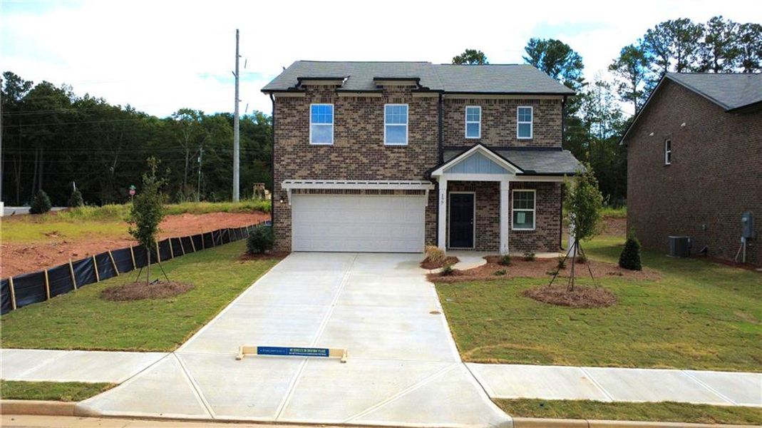 Front exterior of a new home in Kendall Grove, McDonough, GA, highlighting curb appeal (Image 2). Front exterior of a new home in Kendall Grove, McDonough, GA, highlighting curb appeal (Image 2).
