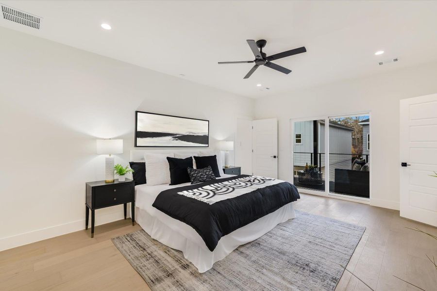 The primary suite balances bold black accents with soft white textures, anchored by a wall-to-wall view of your private balcony—perfect for sipping morning coffee while the neighborhood wakes up.