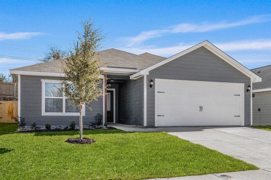 Ranch-style home with a front yard and a garage