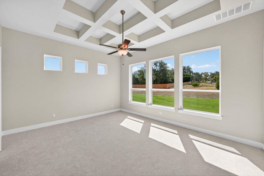 Unfurnished room featuring coffered ceiling, beamed ceiling, a ceiling fan, and light carpet Unfurnished room featuring coffered ceiling, beamed ceiling, a ceiling fan, and light carpet