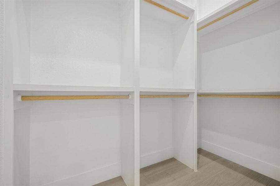 Spacious closet with wood finished floors