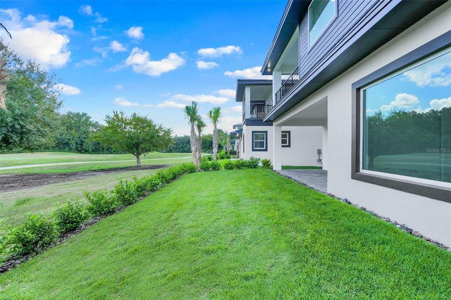 Exterior details and patio area of a home in Hampton Green at Providence, Davenport (Image 33).