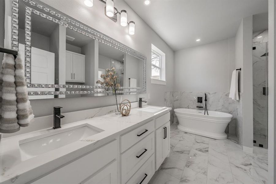 Bathroom with vanity and separate shower and tub