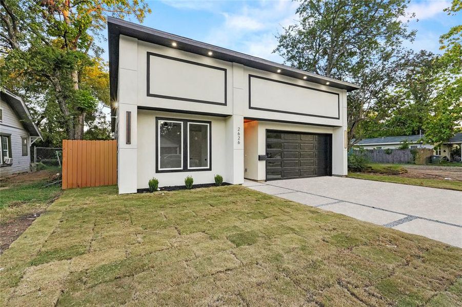 Contemporary home with driveway, stucco siding, and a garage Contemporary home with driveway, stucco siding, and a garage