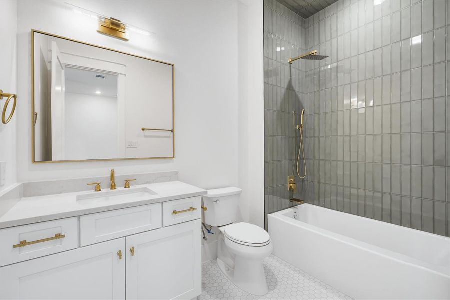 Each secondary bedroom has an attached bath featuring natural stone countertops and accent tiles in the shower.