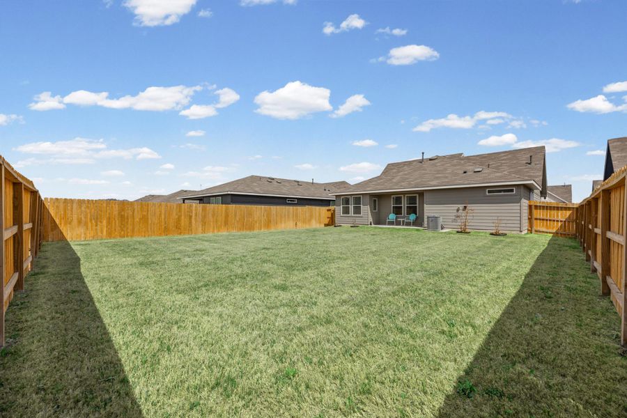 Rear view of property featuring a fenced backyard and a patio area