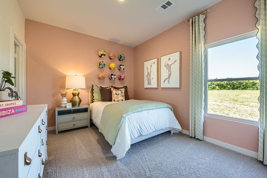 A bedroom with a large window. A bedroom with a large window.