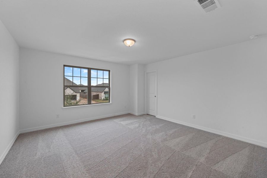 Your secondary bedroom features plush carpet, fresh paint, closet, and a large window that lets in plenty of natural lighting.