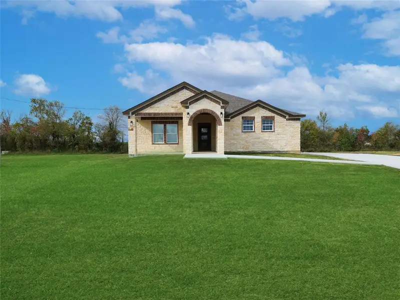 Front exterior of a new home in , Dayton, TX, highlighting curb appeal (Image 2). Front exterior of a new home in , Dayton, TX, highlighting curb appeal (Image 2).