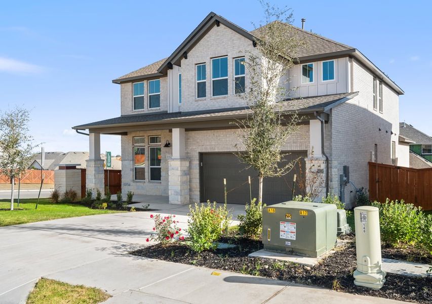 Front exterior of a new home in Park Collection at Lariat, Liberty Hill, TX, highlighting curb appeal (Image 24).