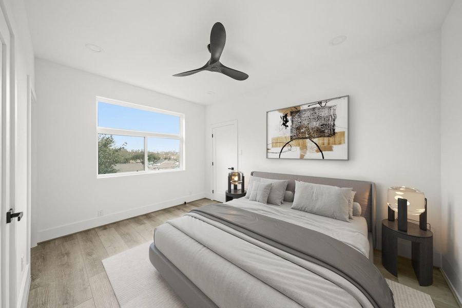 The second bedroom has luxury vinyl floors, recessed lights, a large sliding window with a transom window above, a ceiling fan and a walk-in closet. This photo has been virtually staged. The second bedroom has luxury vinyl floors, recessed lights, a large sliding window with a transom window above, a ceiling fan and a walk-in closet. This photo has been virtually staged.