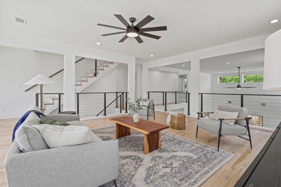 Living room featuring light hardwood / wood-style flooring and ceiling fan