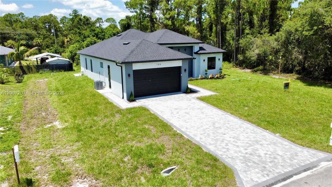 Front exterior of a new home in , Lehigh Acres, FL, highlighting curb appeal (Image 2). Front exterior of a new home in , Lehigh Acres, FL, highlighting curb appeal (Image 2).