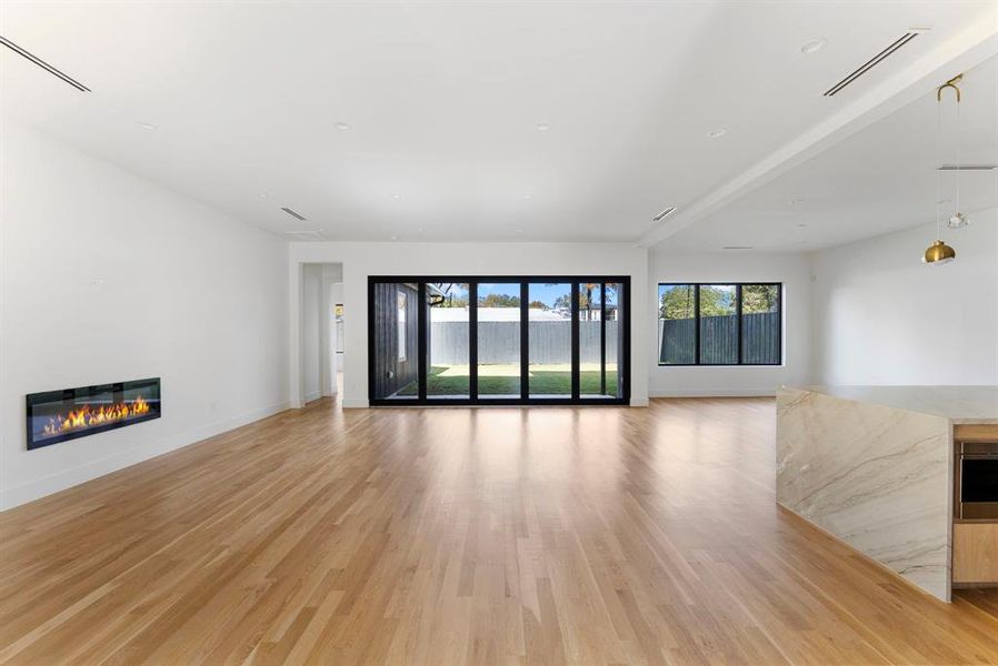 Living Room featuring a glass covered fireplace and hardwood flooring Living Room featuring a glass covered fireplace and hardwood flooring