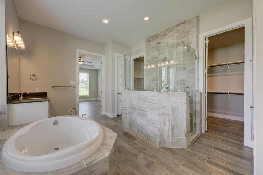 The primary retreat is the perfect space to begin and end each day. Tucked away from the additional bedrooms, the primary suite highlights a tall ceiling and plenty of natural light with views into the large back yard.