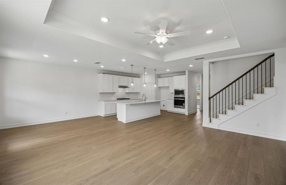 Spacious gathering with view of kitchen