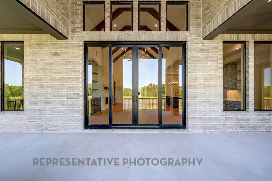 Doorway to property featuring brick siding and a patio Doorway to property featuring brick siding and a patio