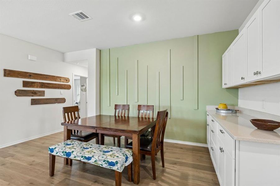 Dining room with wood finished floors and recessed lighting Dining room with wood finished floors and recessed lighting