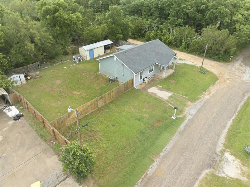Expansive property featuring a light blue exterior, dark shingle roof, and a covered front porch