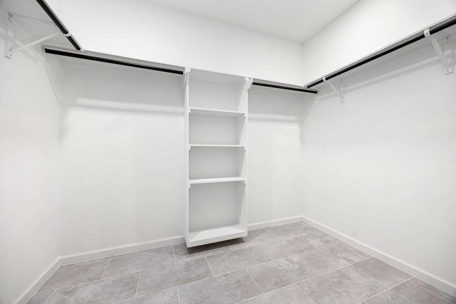 Expansive primary closet with ample shelving and hanging space for perfect organization. Expansive primary closet with ample shelving and hanging space for perfect organization.