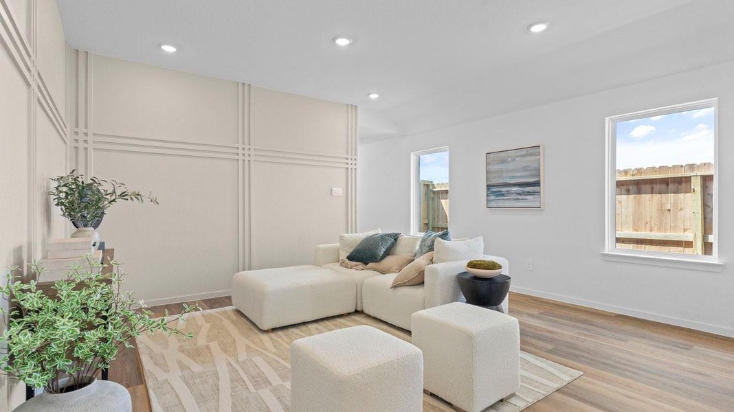 A cozy living room featuring a comfortable couch, a stylish coffee table, and an elegant painting on the wall.