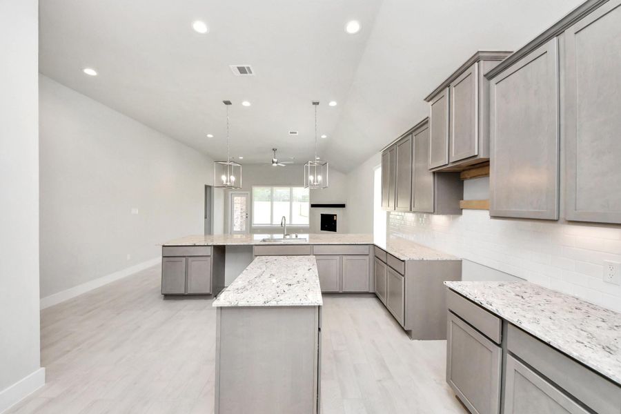 The open concept effortlessly connects the kitchen to the expansive family room, forming a perfect hub for gatherings. This seamless flow creates an inviting space where cooking and socializing come together harmoniously. Sample photo of completed home with similar floor plan. Actual colors and selections may vary.