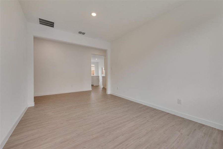 Empty room with light hardwood / wood-style floors