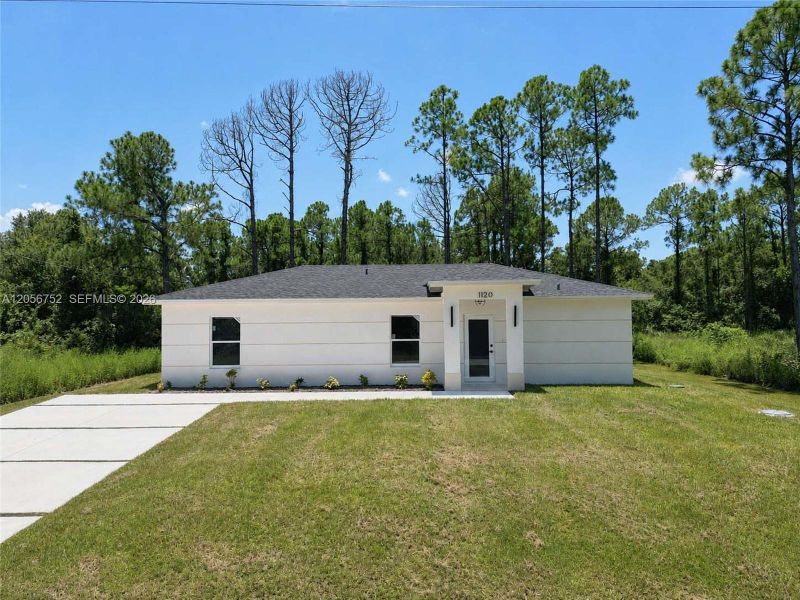 Front exterior of a new home in , Lehigh Acres, FL, highlighting curb appeal (Image 18). Front exterior of a new home in , Lehigh Acres, FL, highlighting curb appeal (Image 18).