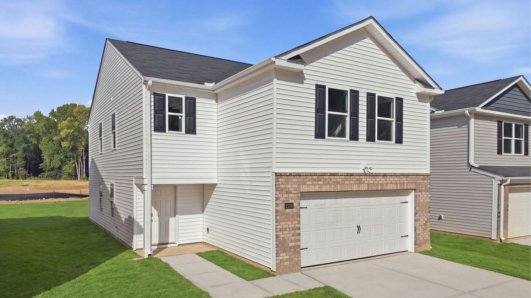 Front exterior of a new home in Carter Ridge, Greenville, NC, highlighting curb appeal (Image 2). Front exterior of a new home in Carter Ridge, Greenville, NC, highlighting curb appeal (Image 2).