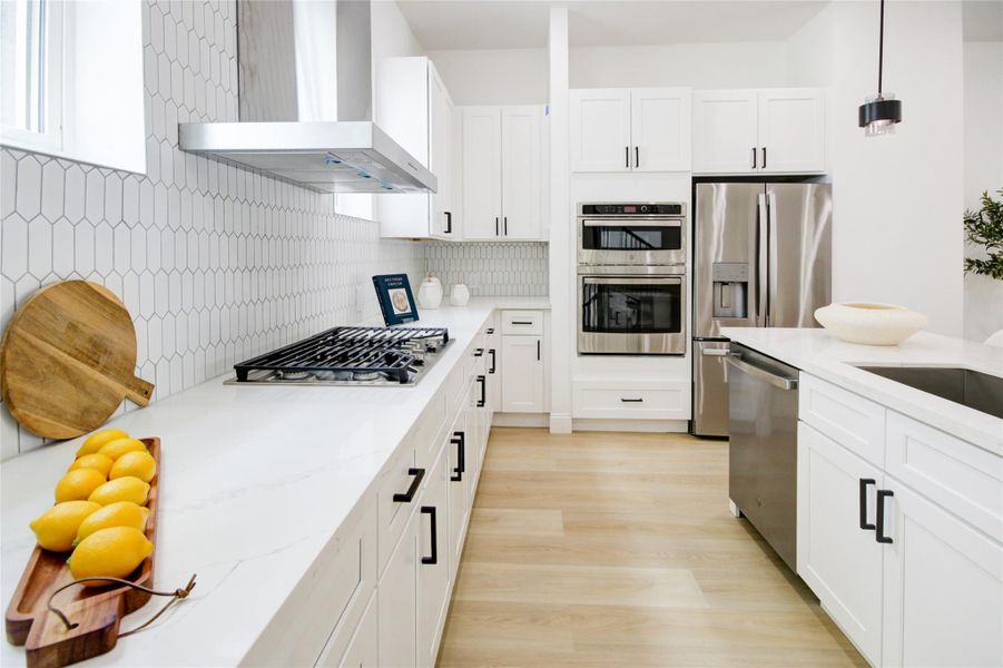 Gas cooktop and island with sink and dishwasher make this kitchen extremely functional. The double oven makes entertaining a breeze as well.