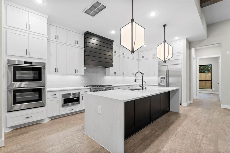 Kitchen view showing flex space or office in the background.