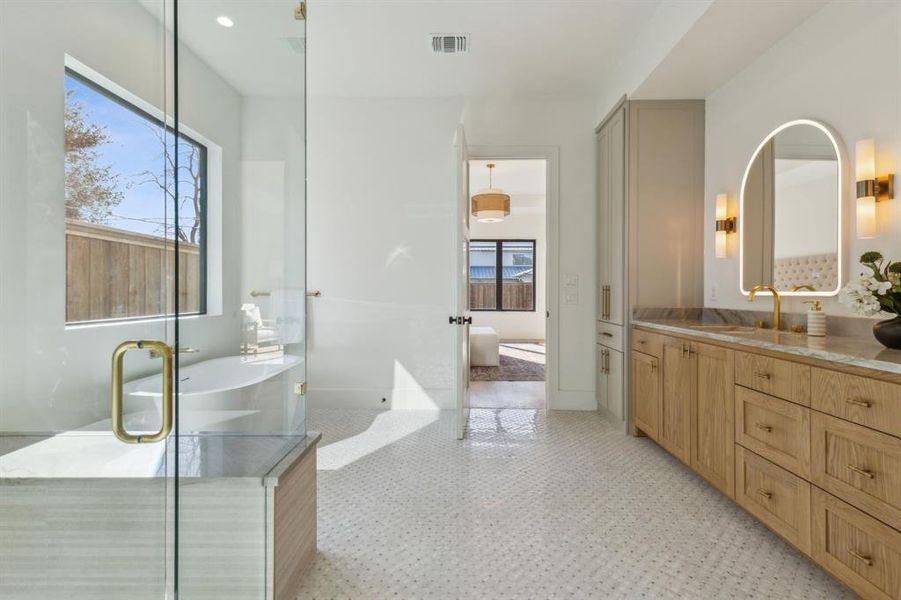 Bathroom featuring tile patterned flooring, vanity, and walk in shower