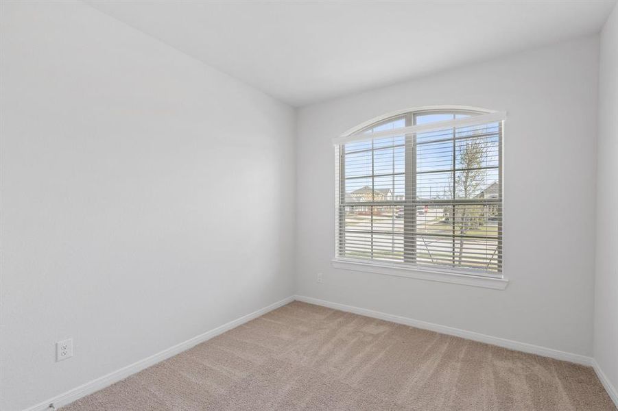 Following the flow of the home from the front off of the main entryway is secondary bedroom #1.