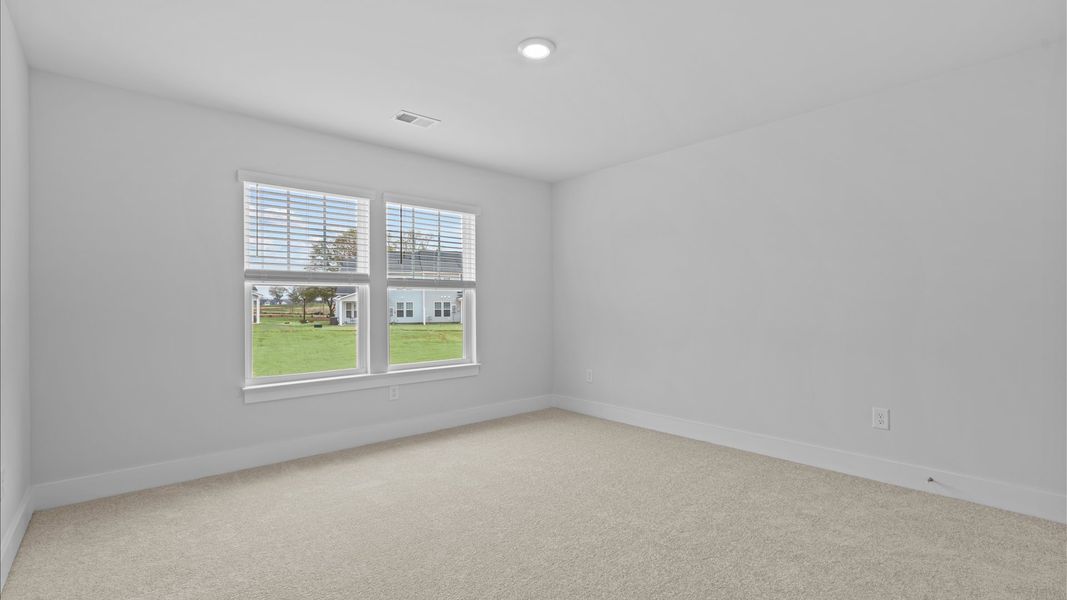 Vibrant and restful bedroom with oversized windows, refined detail, and a warm, welcoming atmosphere
