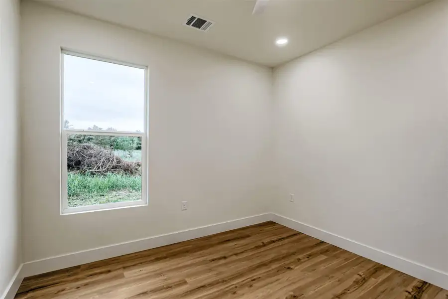Cozy bedroom with modern finishes and a functional layout perfect for guests or family